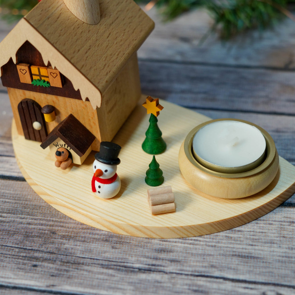Snowman figurine beside German smoke house