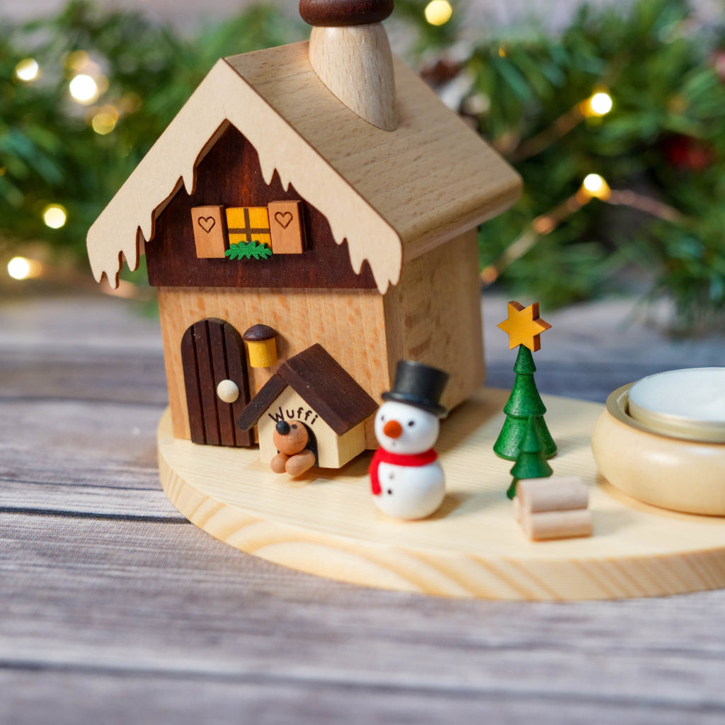 Wooden dog house miniature next to festive smoke house