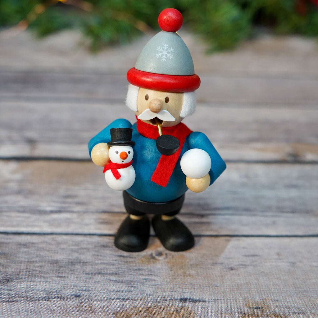 Mini Snowman Smoker on a wooden surface with festive decorations