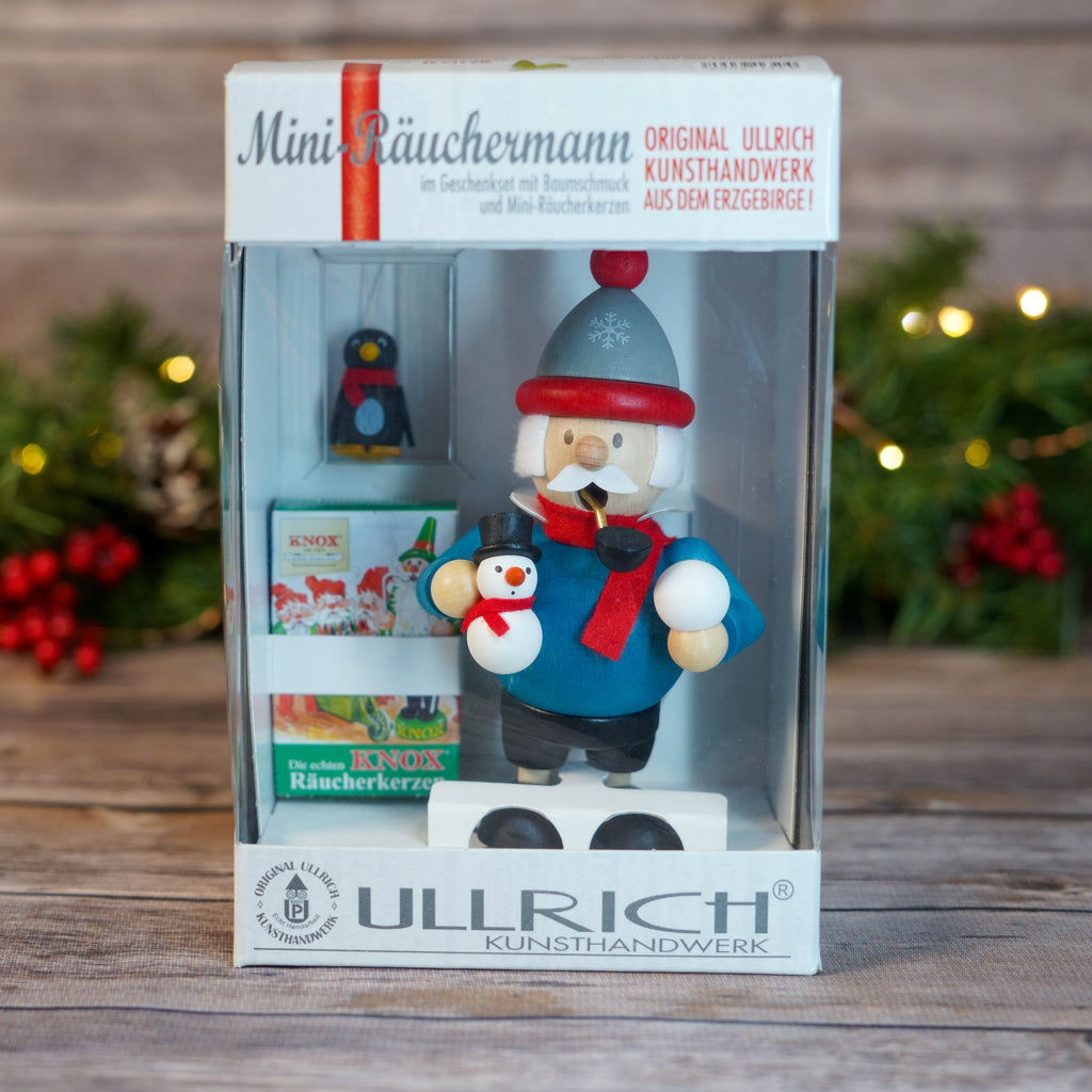 Mini Snowman Smoker in a holiday setting with lit background