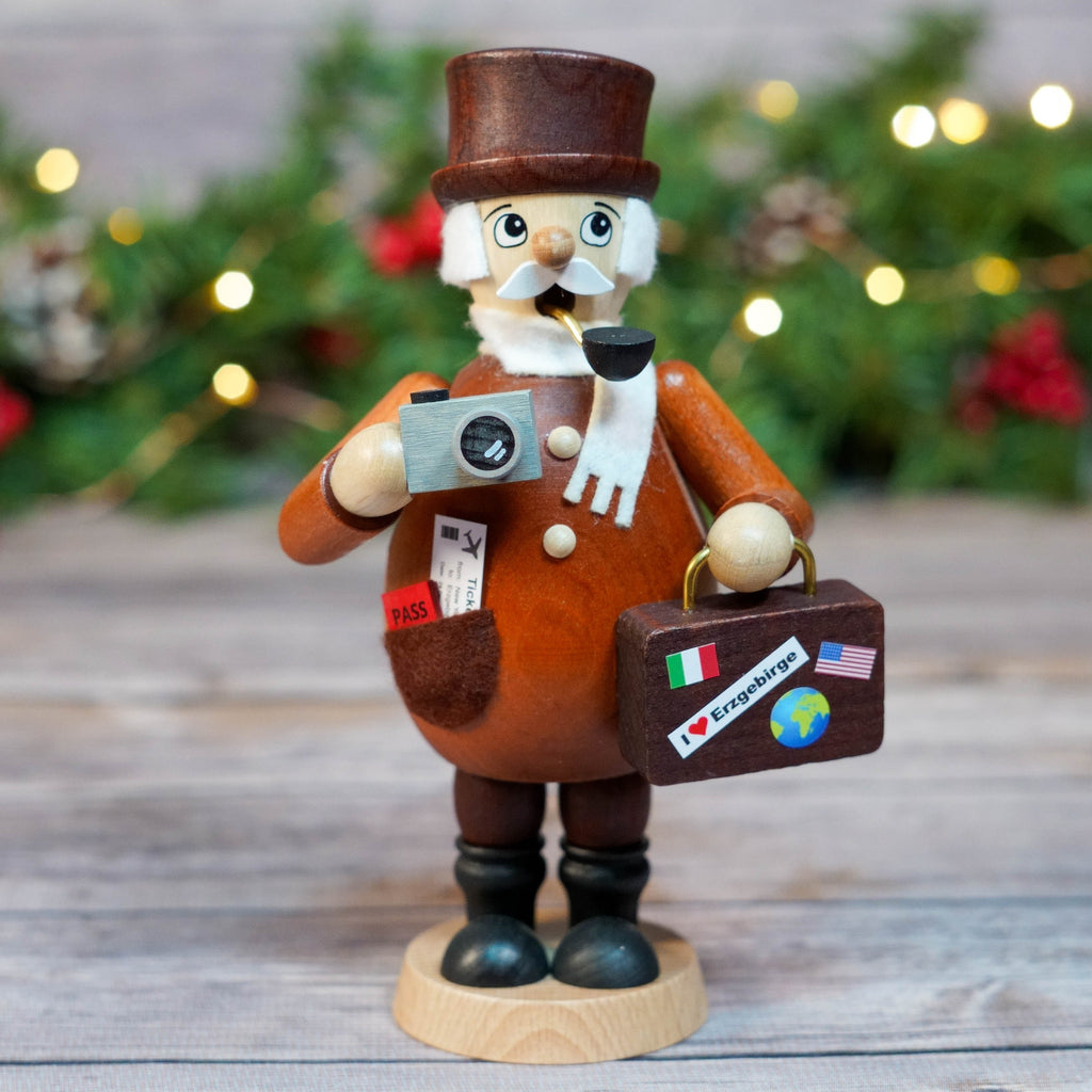 Doctor Smoker figurine holding passport and travel bags