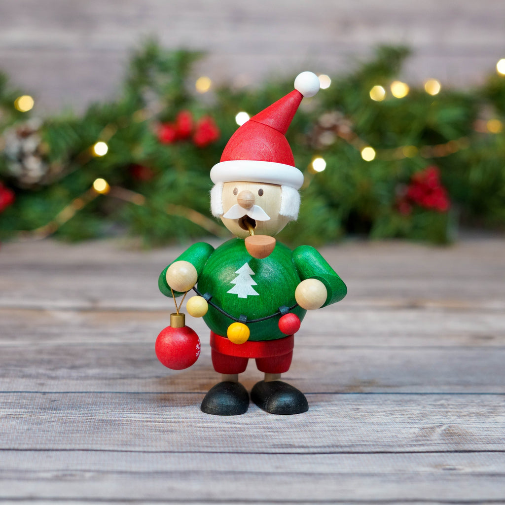 Mini Santa Smoker with green sweater and red hat in festive setting