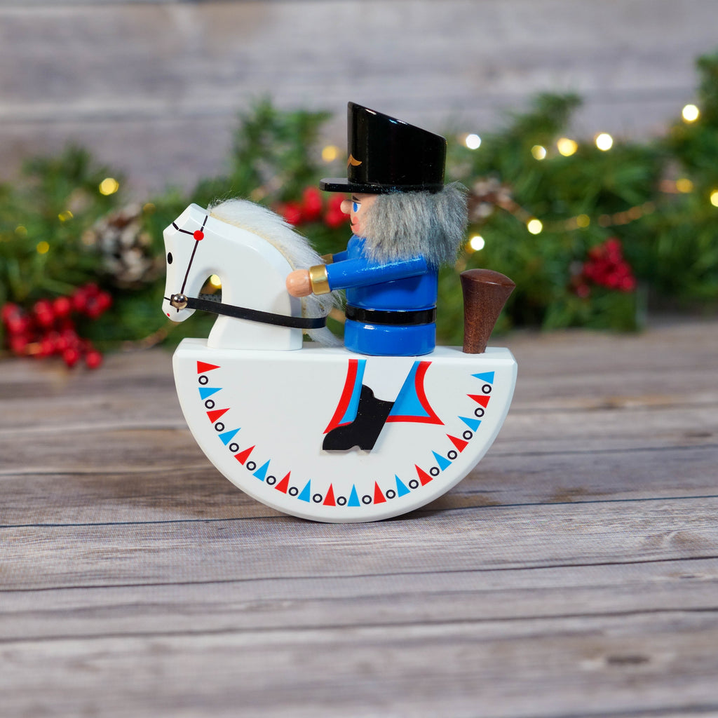 Blue Rocker Horse Nutcracker on wooden table with Christmas background