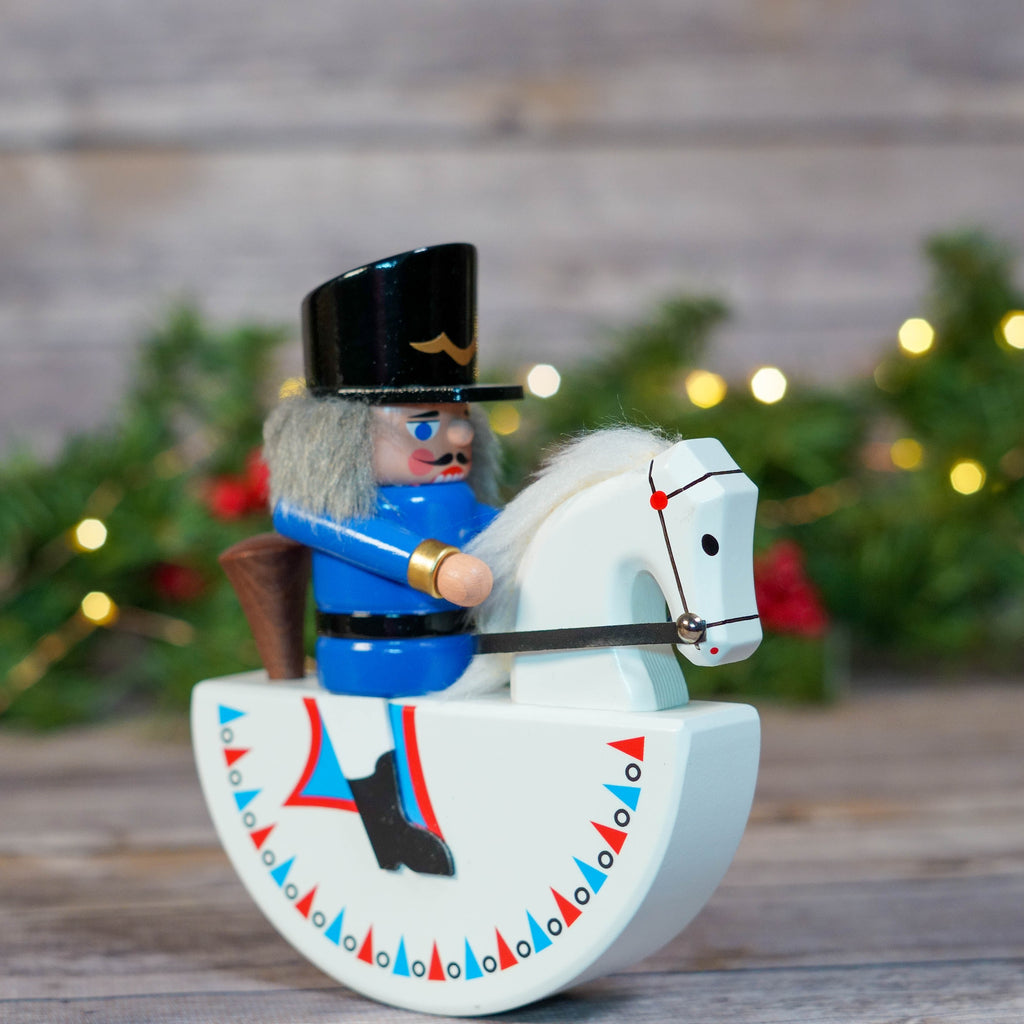 Full front view of Blue Rocker Horse Nutcracker on festive background