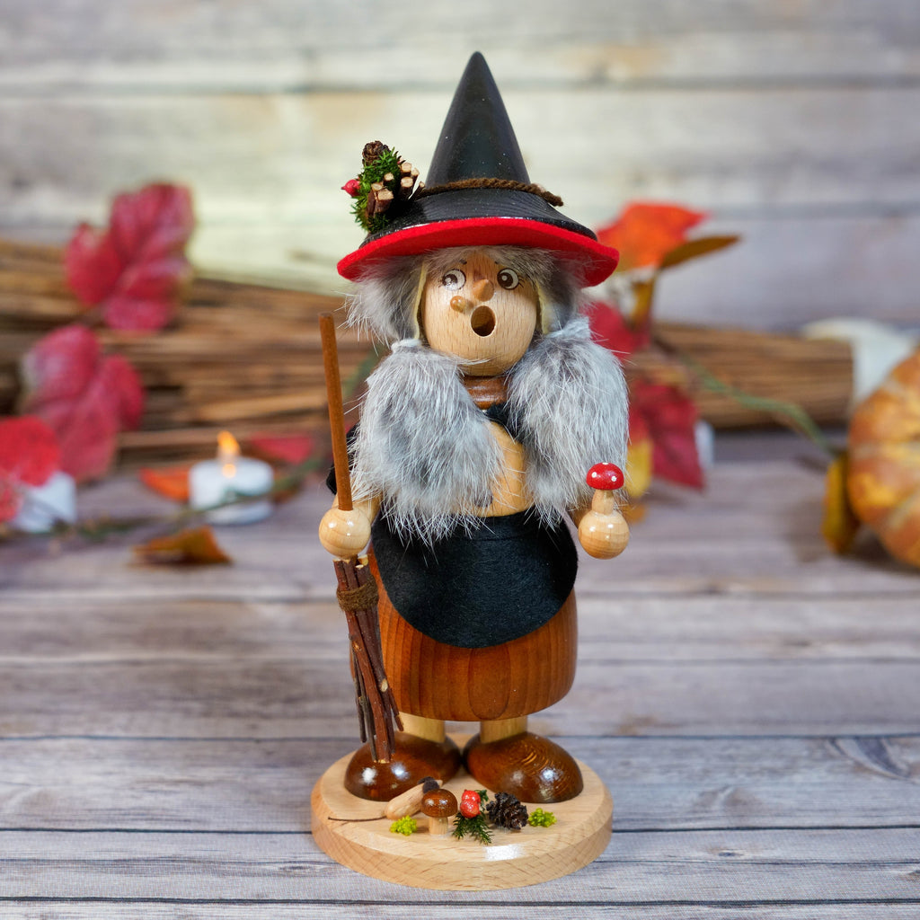 Erzgebirge witch smoker with black hat and cape