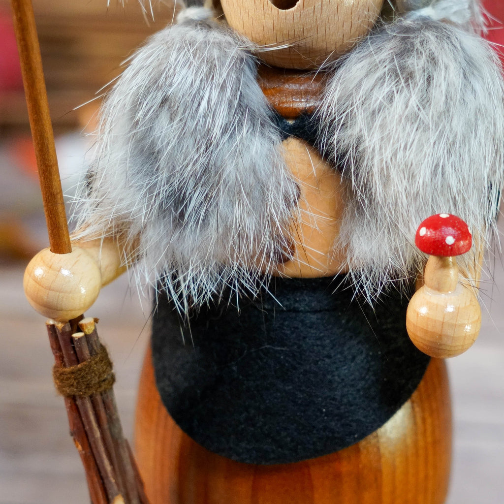 Witch incense smoker surrounded by autumn leaves