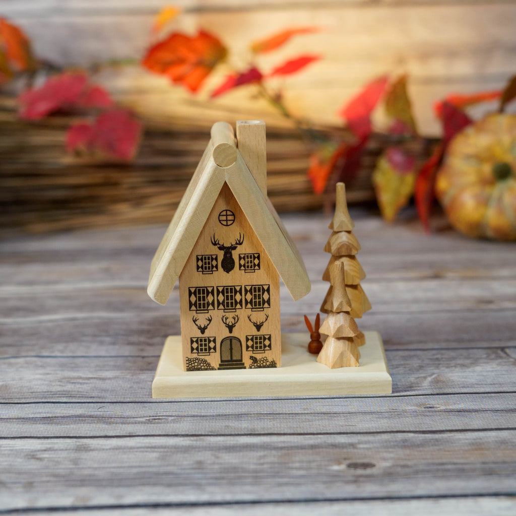 Handcrafted wooden smoker house with intricately etched designs