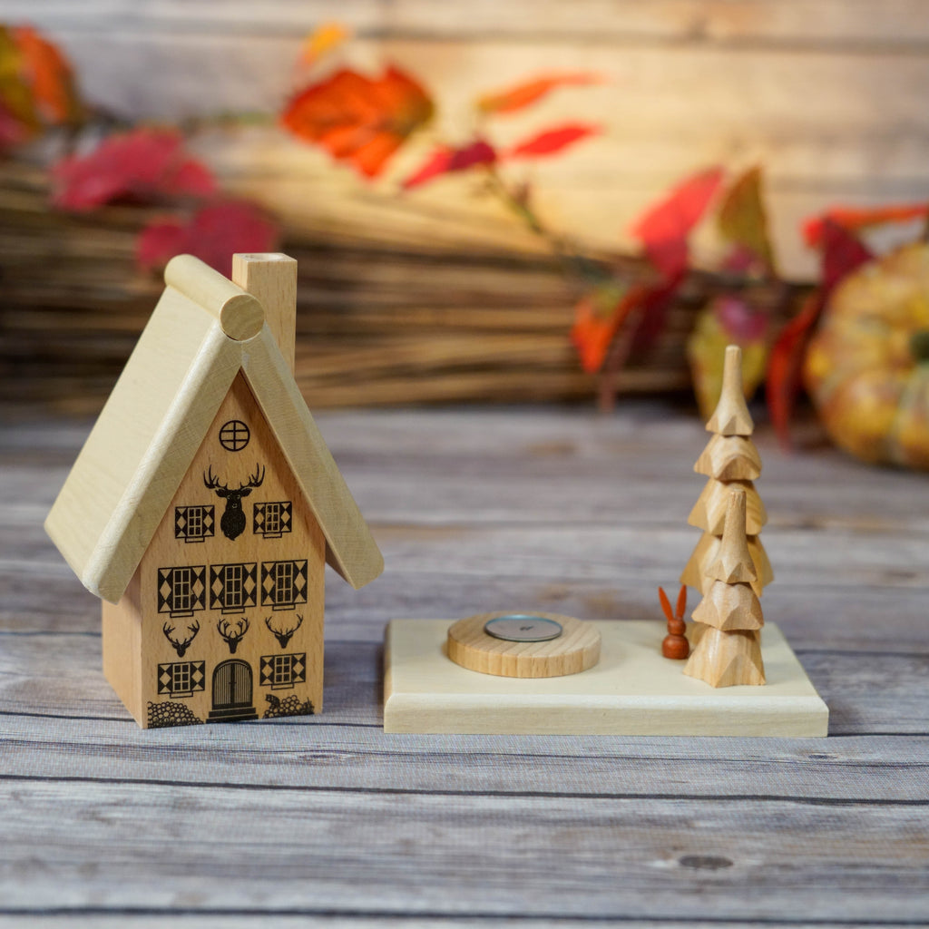 Wooden smoker house next to a hand-carved wooden tree