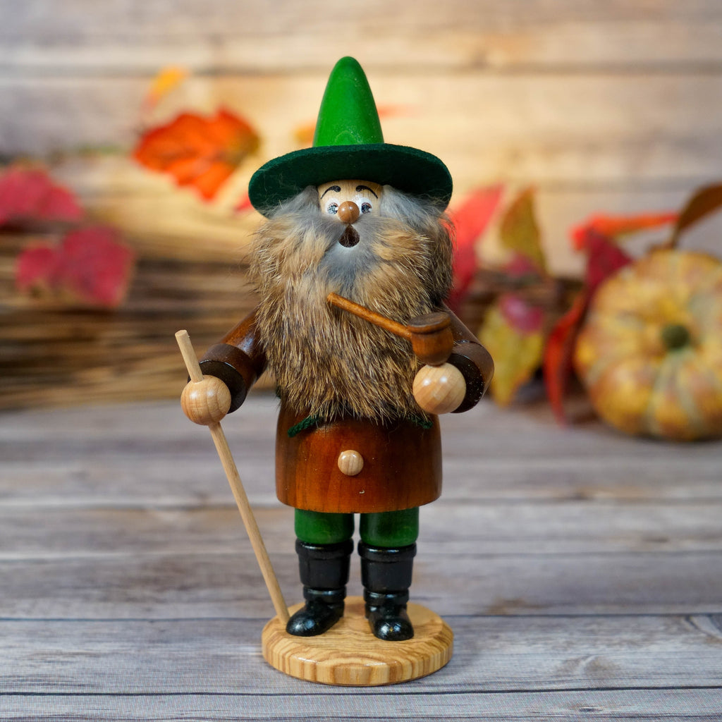 Handcrafted Erzgebirge smoker with green hat and wood staff