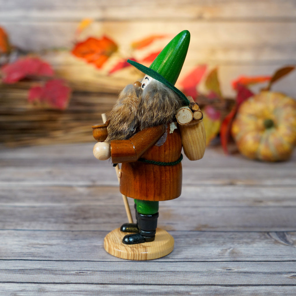 Traditional Erzgebirge smoker holding a staff