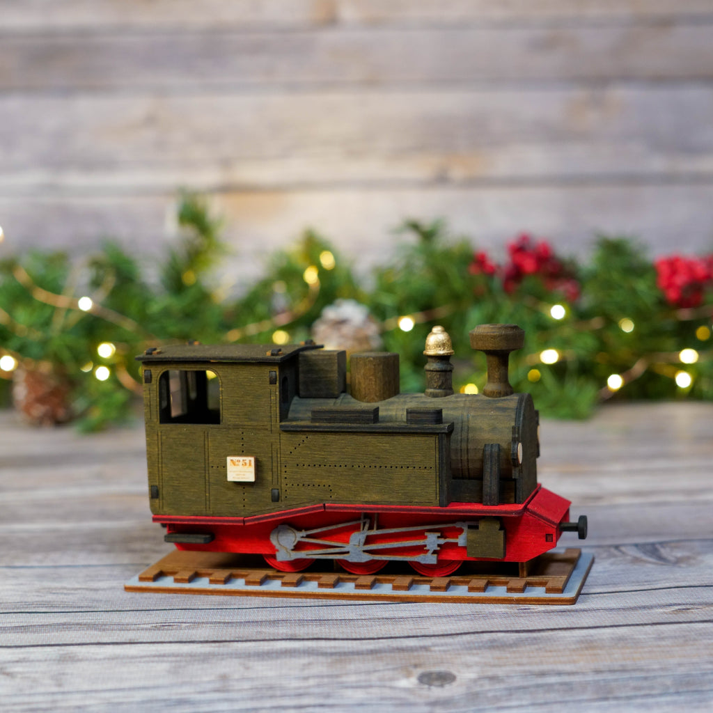 Authentic German Erzgebirge incense smoker shaped like a train with festive background