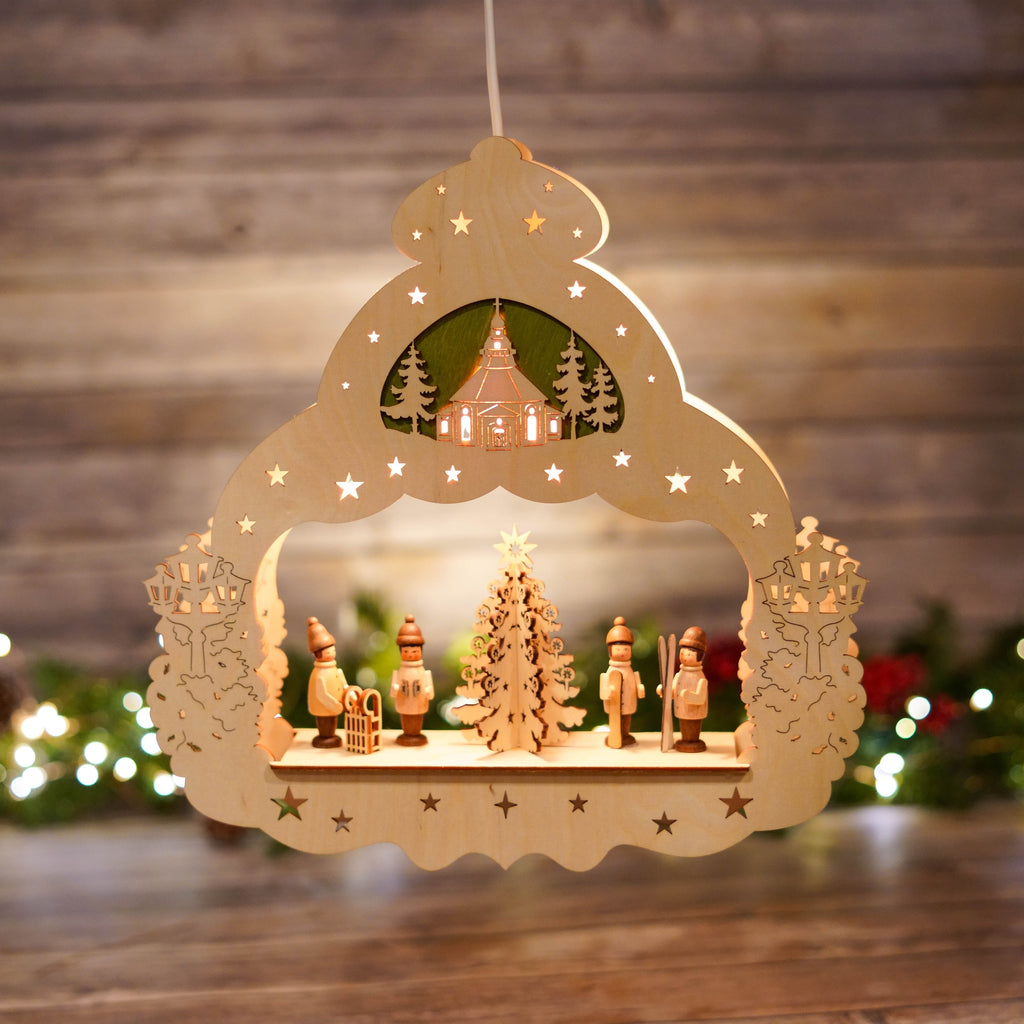 Illuminated window star with winter sports scene