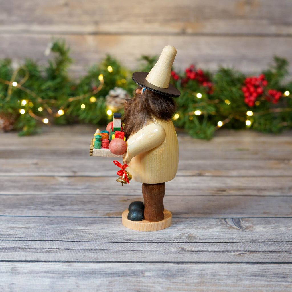 Handcrafted German smoker holding colorful wooden toys