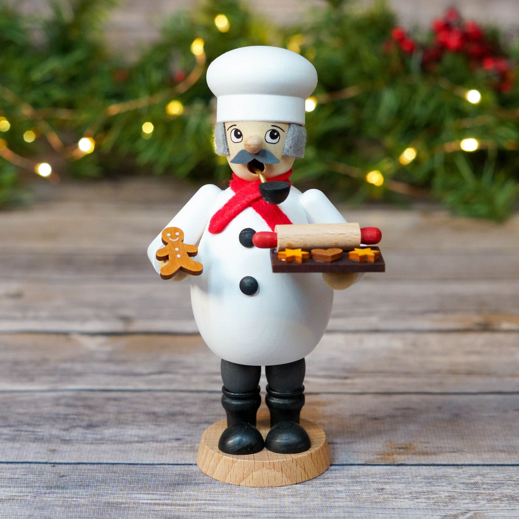 Baker smoker with rolling pin and cookies against festive background