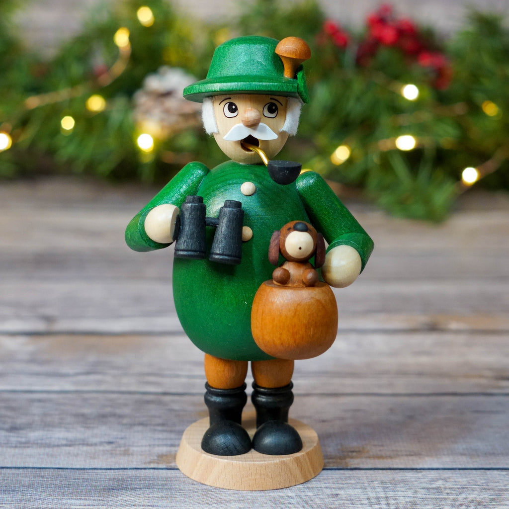 German smoker in green outfit with binoculars and little dog