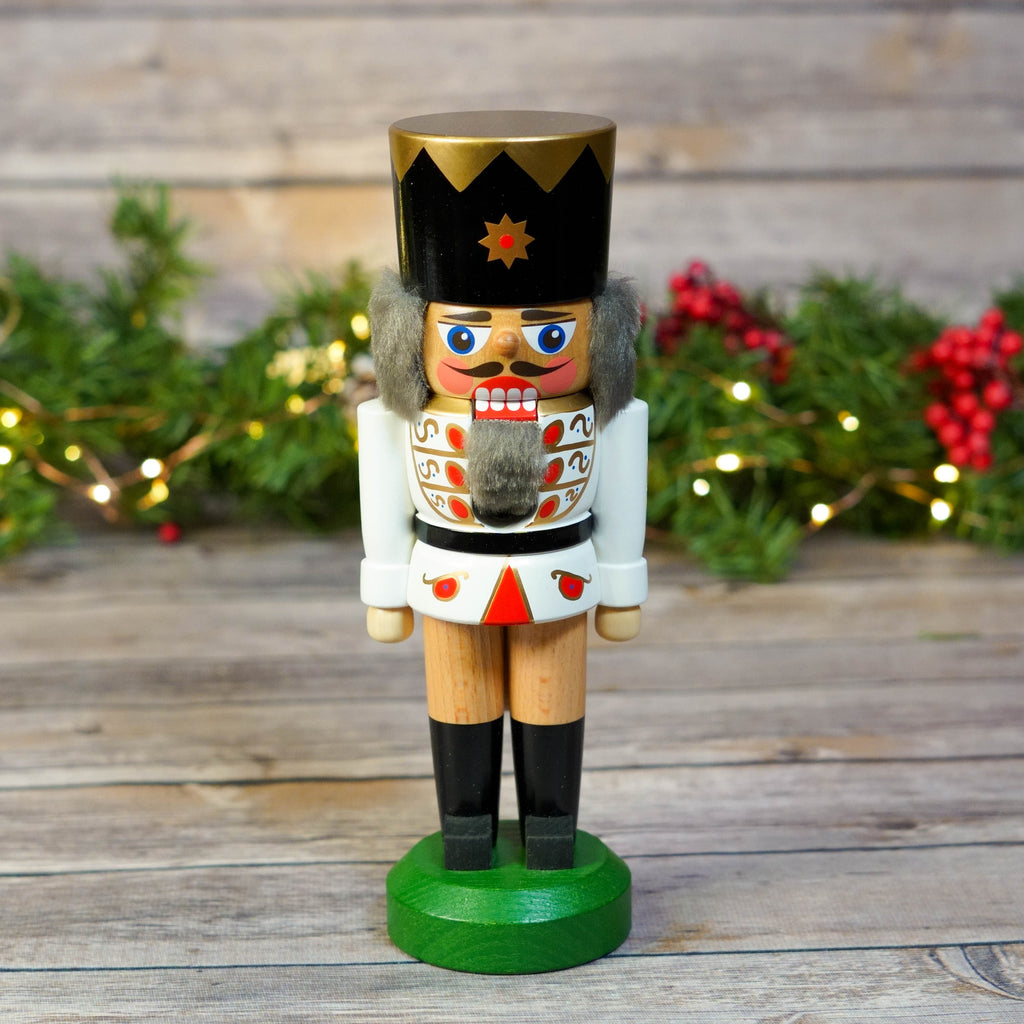 Traditional King Nutcracker in White with Christmas Decor Background