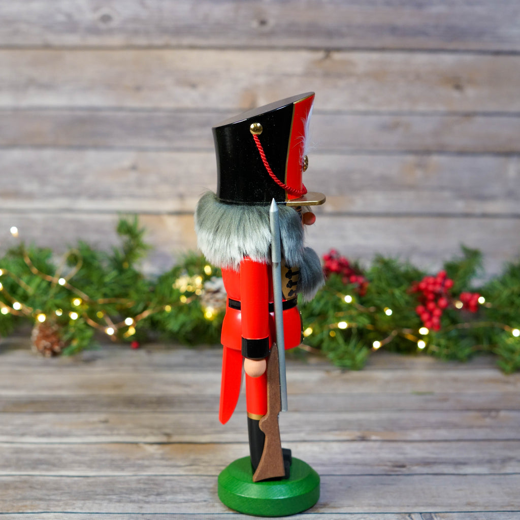 Nutcracker Soldier on wooden background with festive decor