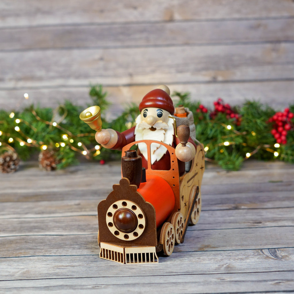 Santa Claus driving a wooden train smoker with Christmas lights