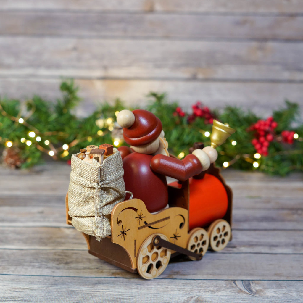 Artisanal Santa Claus train smoker against wooden backdrop