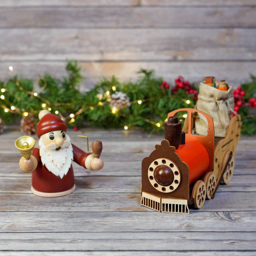 Close-up of wooden train wheels and Santa figure