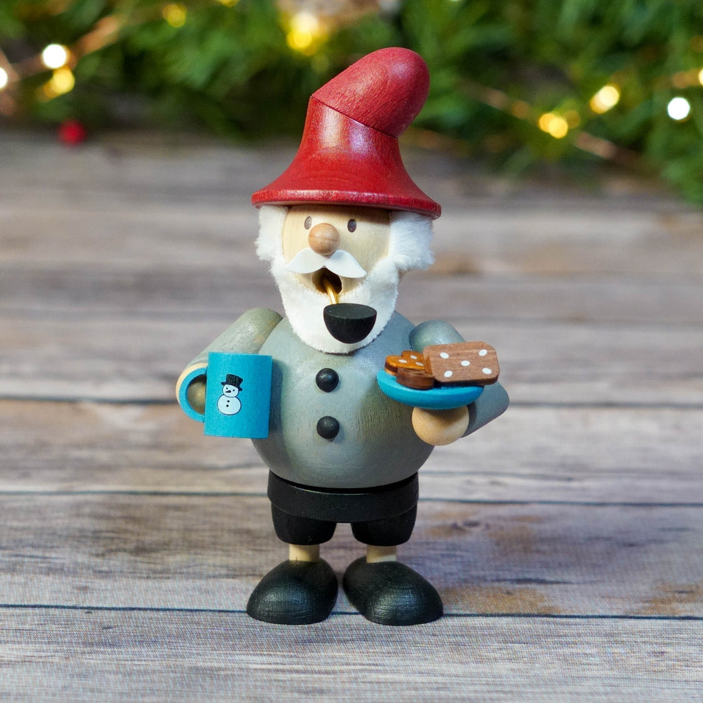 Gnome with red hat holding cookies and hot chocolate