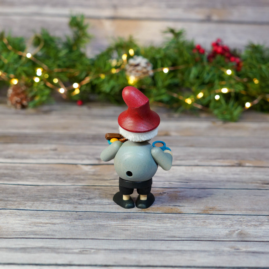 Gnome smoker beside Christmas decorations