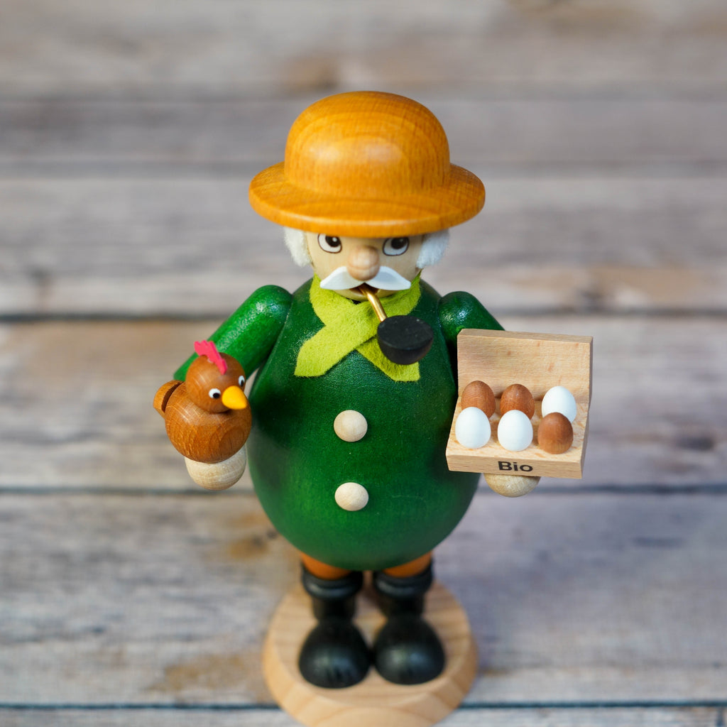 Farmer Smoker Holding a Chicken Close-up View