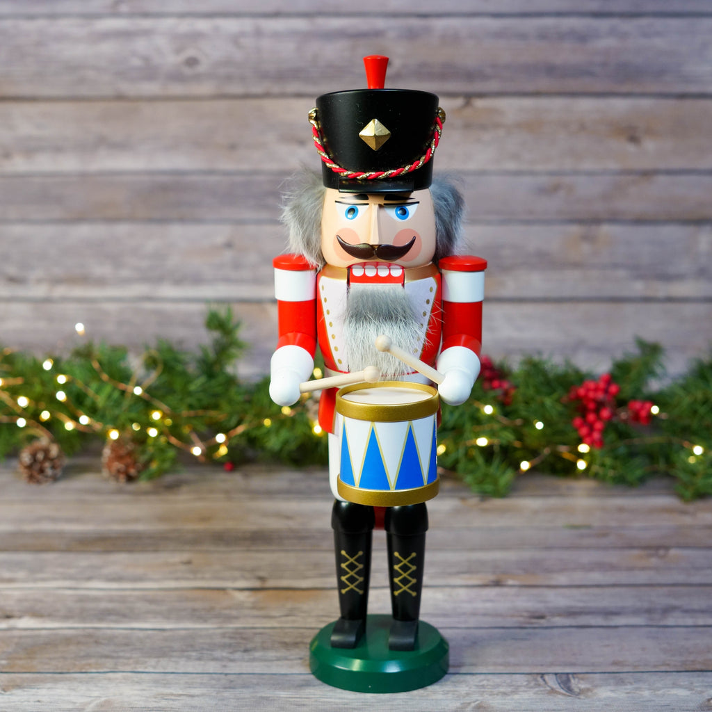 Full front view of traditional drummer nutcracker amidst Christmas decor