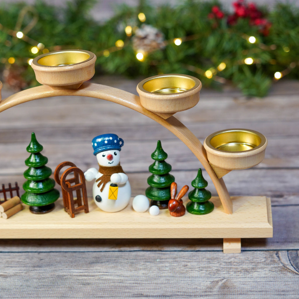 Detailed view of Snowman and Rabbit on wooden candle arch