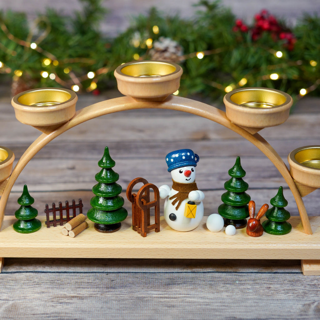 Close-up of candle holders and festive figurines on Schwibbogen