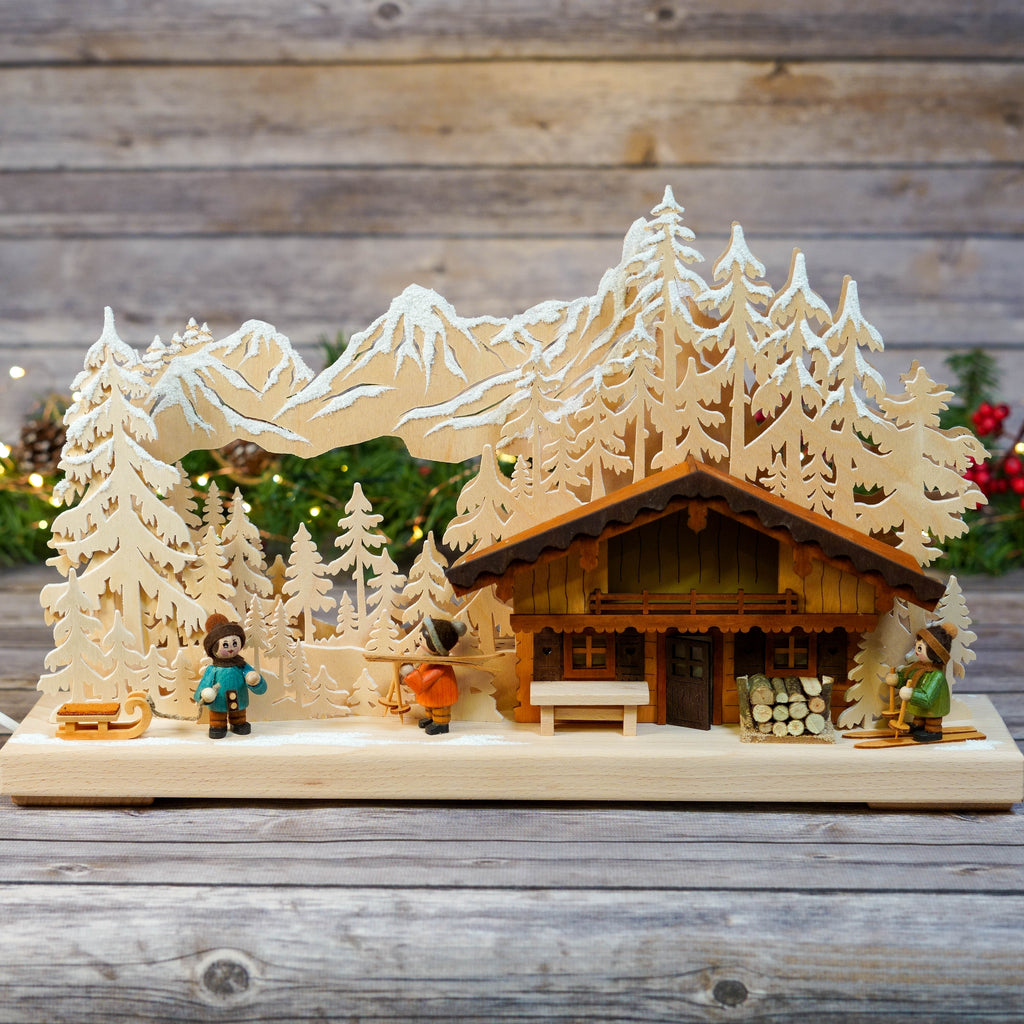 Handcrafted wooden Schwibbogen depicting a ski lodge scene
