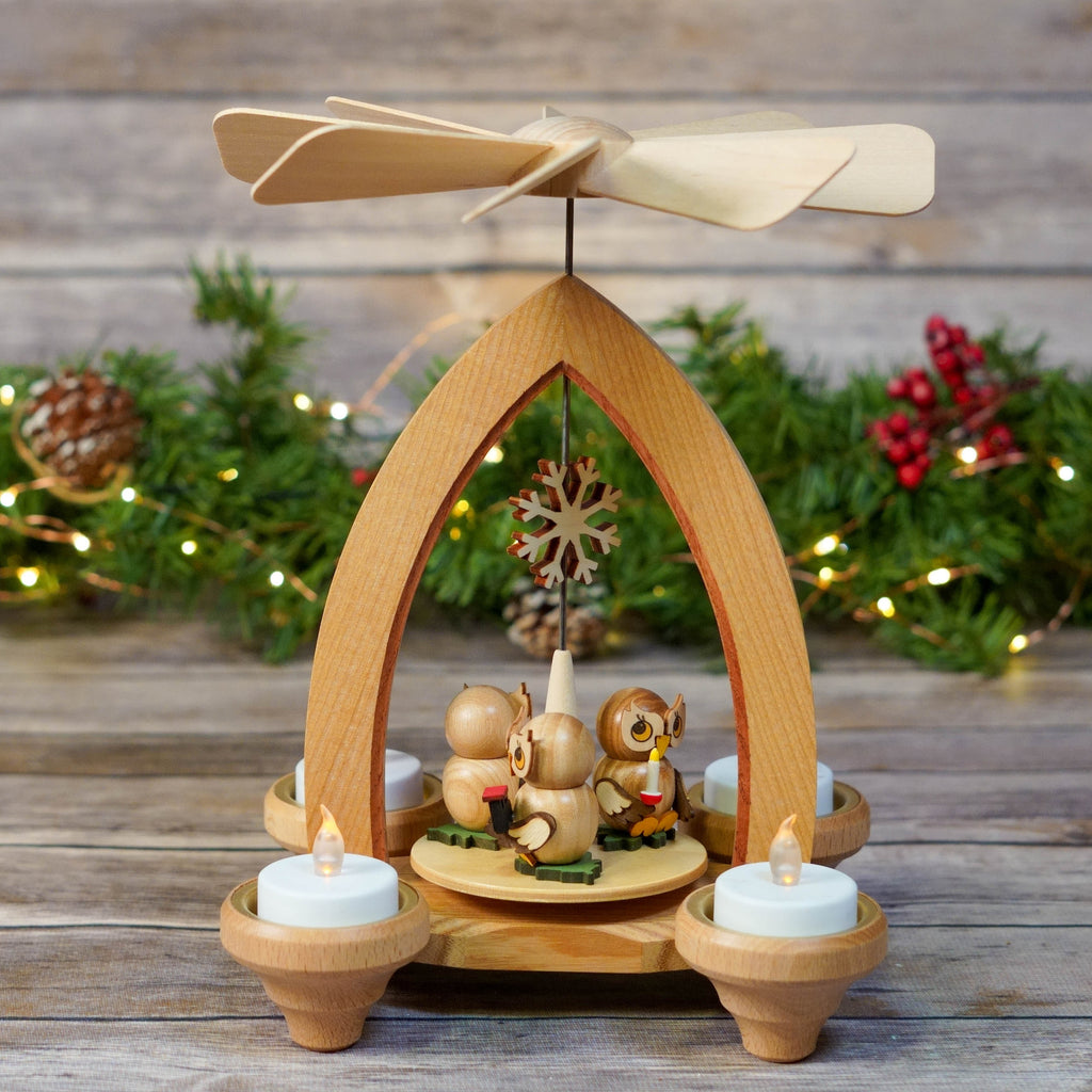 Traditional German Christmas Pyramid with owls and candles