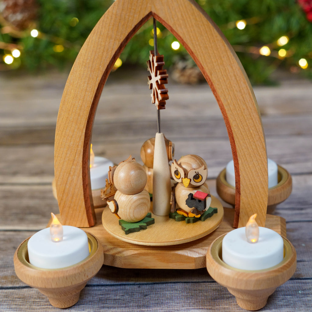Close-up of hand-carved owls on Christmas Pyramid