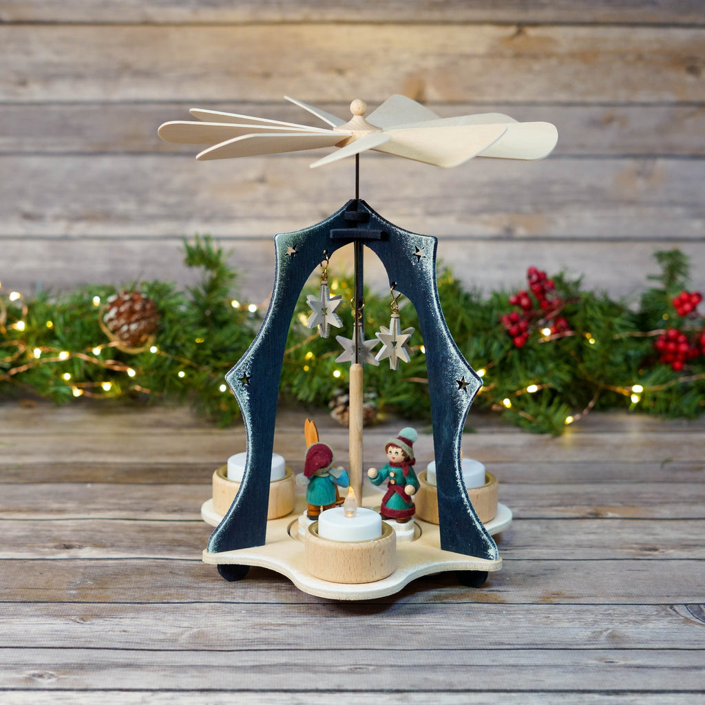 Blue triangular Christmas pyramid with skier figures and star designs