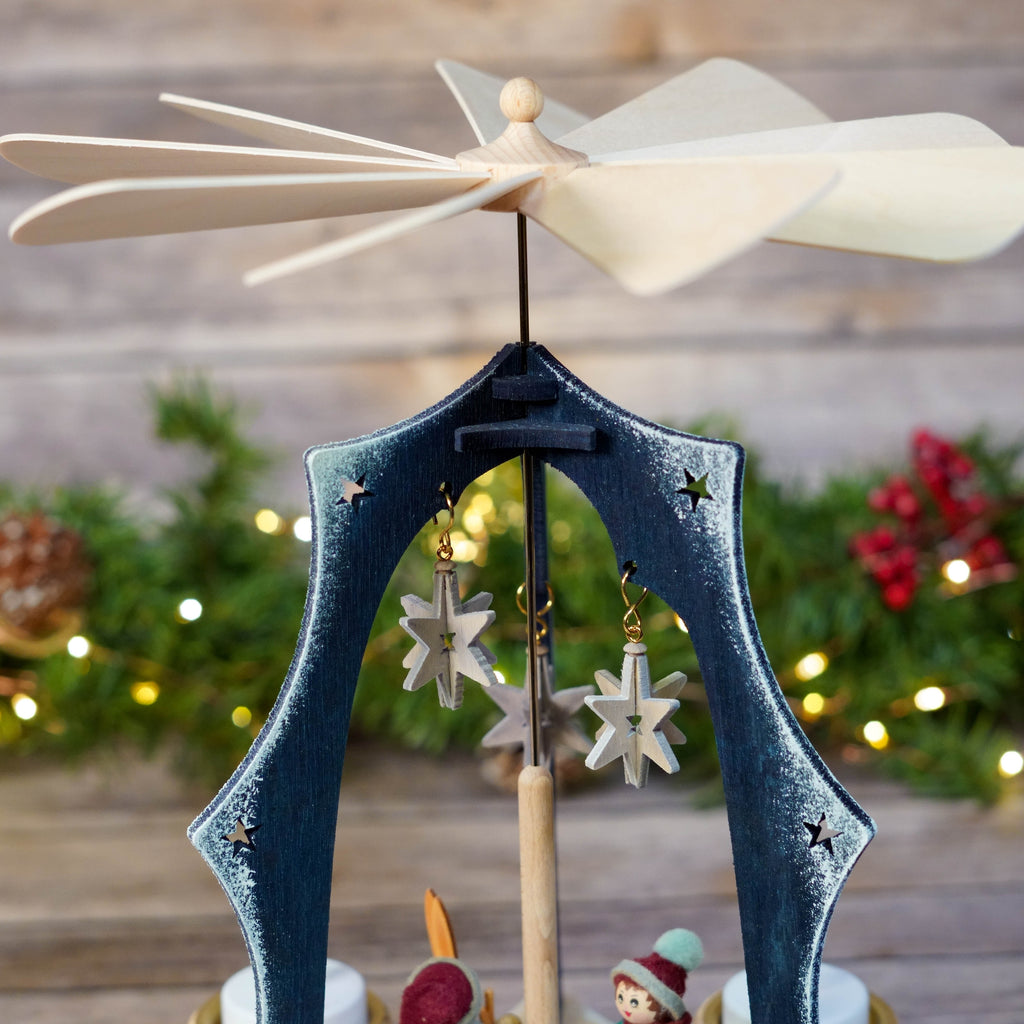 Close-up of wooden skier and star details on Christmas pyramid