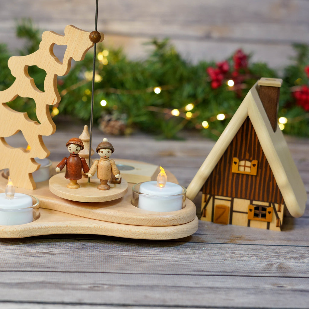Warmly lit scene with Smoker House, festive lights in background