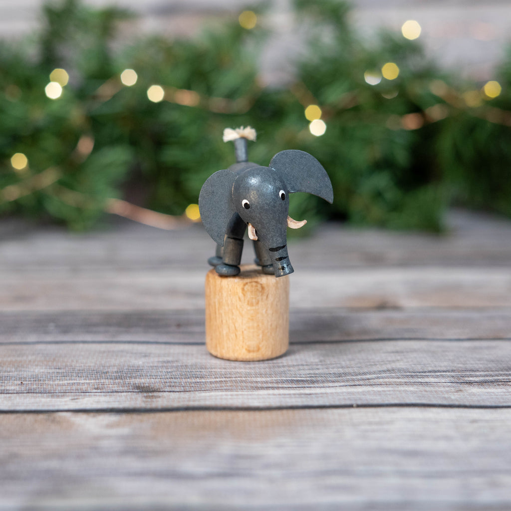Handcrafted Wobbly Elephant Toy with Christmas background