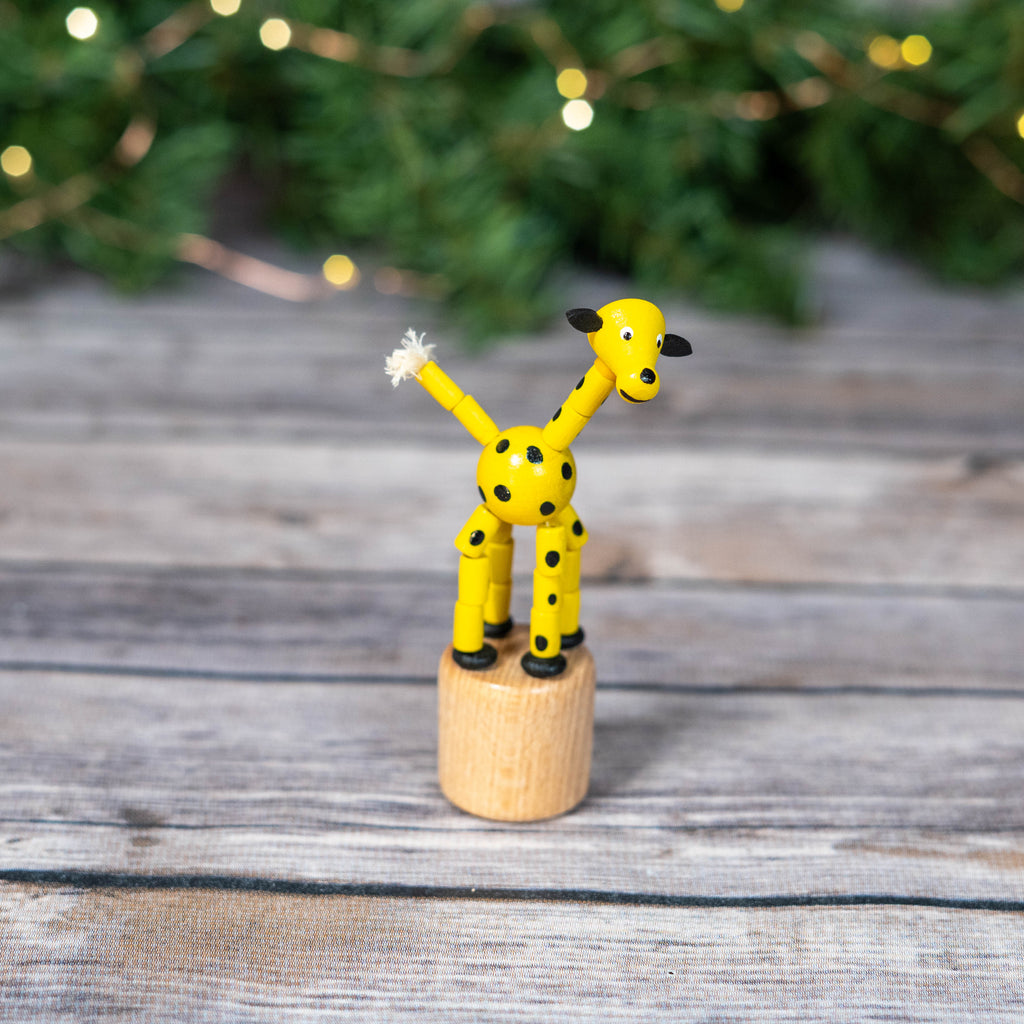 Yellow giraffe play toy with button-activated wobble feature