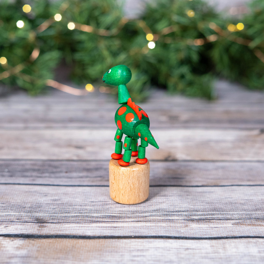 Wobbly green dinosaur on display with twinkling lights